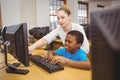 Teacher showing students how to use a computer Royalty Free Stock Photo