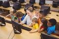 Teacher showing students how to use a computer Royalty Free Stock Photo