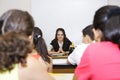 Teacher sitting in front of class Royalty Free Stock Photo