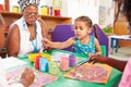 Teacher sitting with kids in a preschool class, close up