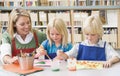 Teacher sitting with students in art class