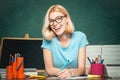 Teacher is skilled leader. Young teacher in glasses over green chalkboard background. Beautiful teacher in classroom