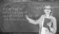 Teacher smart woman with book explain topic near chalkboard. School teacher explain things well and make subject