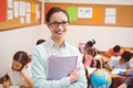 Teacher smiling at camera in classroom Royalty Free Stock Photo