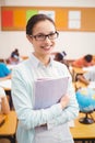 Teacher smiling at camera in classroom Royalty Free Stock Photo