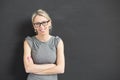Teacher standing in front of blackboard with arms crossed Royalty Free Stock Photo