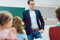 Teacher standing in front of students in school class Royalty Free Stock Photo