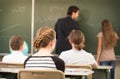 RTeacher teaching or educate at the board a class in schoolr Royalty Free Stock Photo