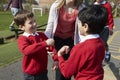 Teacher Stopping Two Boys Fighting In Playground Royalty Free Stock Photo