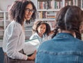 Teacher, storytelling or children in a library for learning development, reading skills or growth. Happy smile, kids or Royalty Free Stock Photo