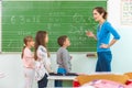 Teacher and student at the blackboard, math class Royalty Free Stock Photo
