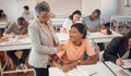 Teacher, student and classroom for test, knowledge and learning for higher education. Young female, black woman or Royalty Free Stock Photo