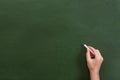 Teacher or student hand holding a chalk stick