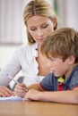 Teacher, student and help with school work in classroom, question and think of answer for education and knowledge Royalty Free Stock Photo