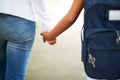 Teacher, student and holding hands while walking to school in outdoor park for support or responsibility. Closeup or Royalty Free Stock Photo