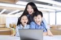 Teacher and students looking at laptop Royalty Free Stock Photo