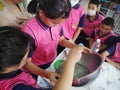 Teacher and students make hand sanitizer.