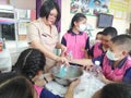 Teacher and students make hand sanitizer.