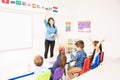 Teacher and students raising their hands Royalty Free Stock Photo