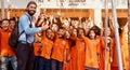 Teacher with the students showing victory sign