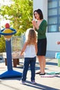 Teacher Supervising Breaktime At Elementary School