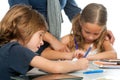 Teacher supervising kids homework. Royalty Free Stock Photo