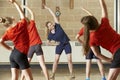 Teacher Taking Exercise Class In School Gym Royalty Free Stock Photo
