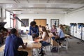 Teacher Talking To Female High School Student Sitting At Work Bench Using Laptop In Design And Technology Lesson Royalty Free Stock Photo