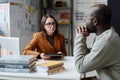 Teacher talking to parent in classroom Royalty Free Stock Photo