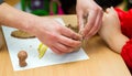 The teacher teaches the student to sculpt with clay.