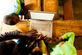 Bafoussam, Cameroon - 06 august 2018: above view of african kids and teacher teaching how to use laptop to increase development