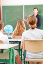 Teacher teaching or educate at the board a class in school Royalty Free Stock Photo