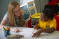 Teacher teaching her student in a classroom.Located in Orlando Florida.