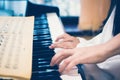 Teacher teaching little girl to play on piano. Concept of music study and creative hobby