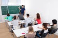 Teacher teaching mathematics to college students Royalty Free Stock Photo