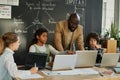Teacher teaching students to use computers Royalty Free Stock Photo