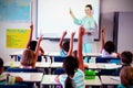 Teacher teaching students using projector in classroom Royalty Free Stock Photo