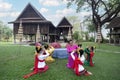 A teacher is teaching Thai dance to students in a Thai style house