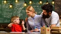 Teacher or tutor helps preschool child, Man looking in laptop display watching training course and listening it, Digital