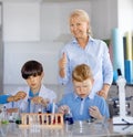 Teacher and Two laboratory assistants kids Royalty Free Stock Photo