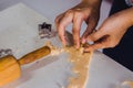 Teacher using cutters on dough for demonstration to teach stude Royalty Free Stock Photo