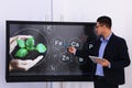 Teacher using interactive board in classroom during lesson Royalty Free Stock Photo