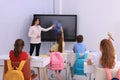 Teacher using interactive board in classroom during lesson Royalty Free Stock Photo