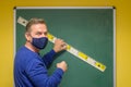 Teacher using a ruler to draw on a chalkboard