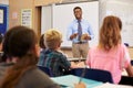 Teacher using tablet computer in an elementary school class Royalty Free Stock Photo