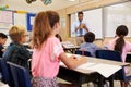 Teacher using tablet computer in an elementary school class Royalty Free Stock Photo