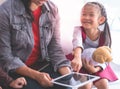 Teacher using tablet to tell little kid stories Royalty Free Stock Photo