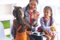 Teacher using tablet to tell little kid stories Royalty Free Stock Photo