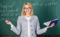 Teacher woman with book chalkboard background. Why teacher quit off sick with stress. Overwork and lack of support Royalty Free Stock Photo