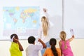 Teacher, woman and children in a classroom, playing and knowledge with information, paper planes and learning. School Royalty Free Stock Photo